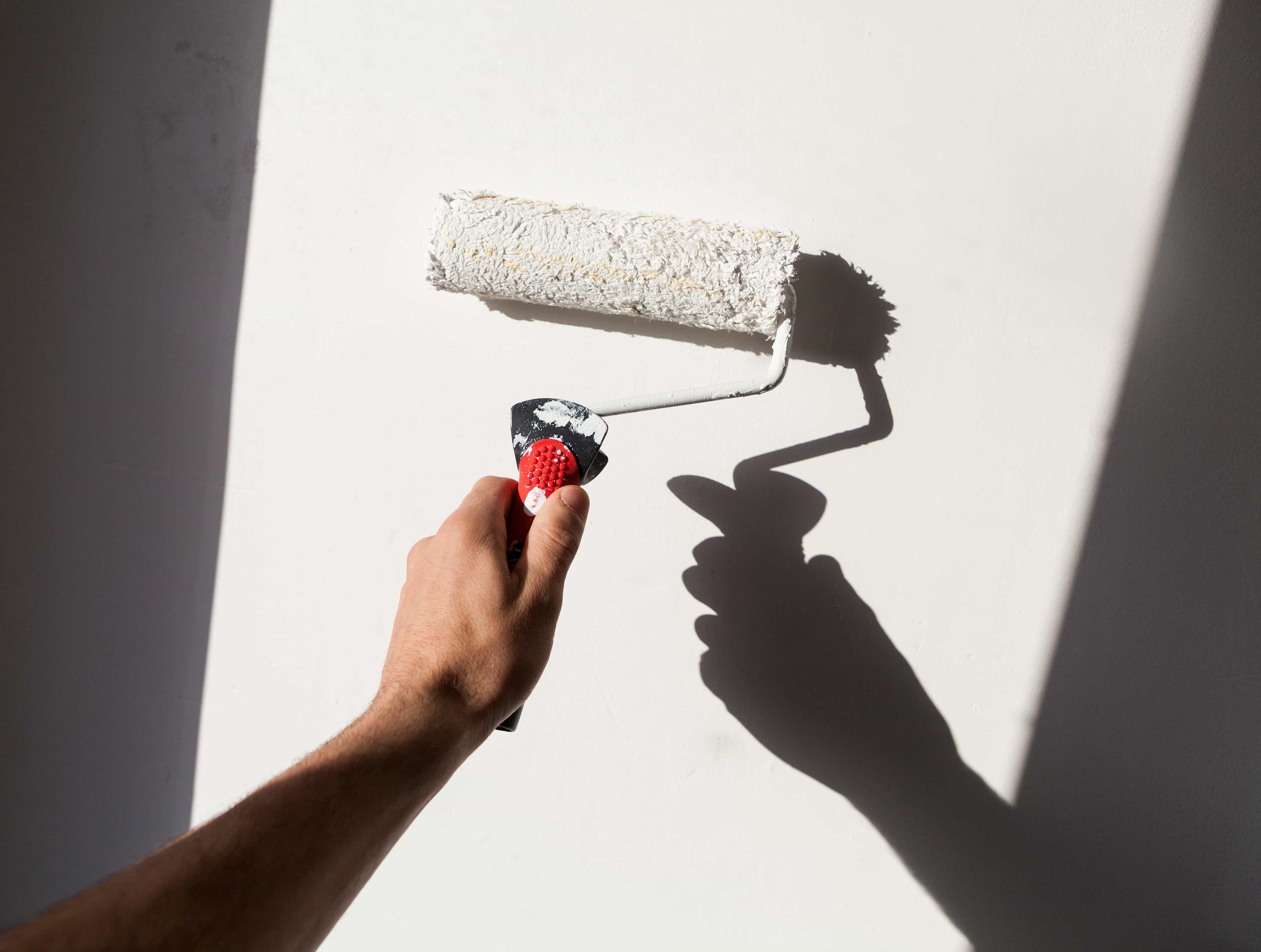 Painter with brush climbing ladder during renovation work